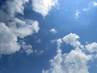 Sky with clouds. Beautiful blue natural background with white cloudy and sun.