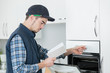 © auremar - Young man installing oven