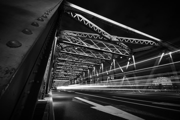 Light trails of traffic on steel bridge at night