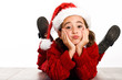 © javiindy - Adorable little girl wearing santa hat laying on wooden floor