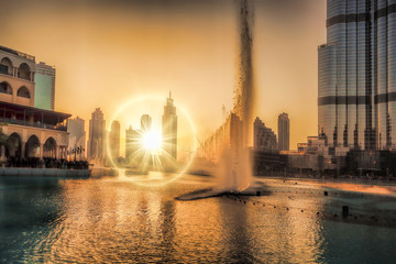 Wall Mural - Dubai lagoon with fountain against sunset in UAE