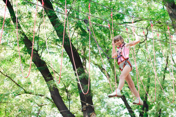 Wall Mural - adventure climbing high wire park - hiking in the rope park girl