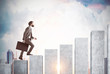 © ImageFlow - Side view of a businessman climbing a graph