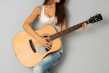 Woman With Big Breast And Guitar In Hands