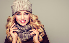 Trendy Warm Winter - Beautiful  Young Blonde  Woman In Gray Wool Winter Hat And Scarf Smiling .  Portrait Of Beauty  Winter Girl  In Knitted  Woolen  Clothing Hat And  Snood . 
