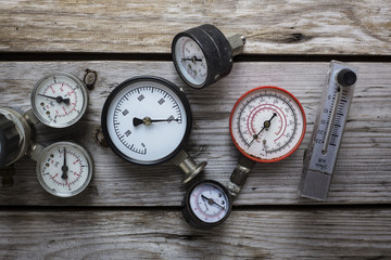 old pressure gauge on wood table background.