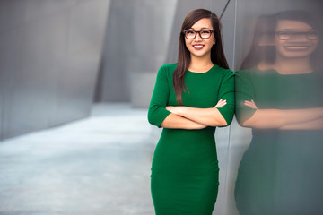 Portrait of confident young successful business woman in modern creative building space