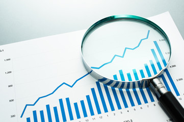 Poster - Reviewing financial report. Looking at growth chart with magnifying glass.
Document, chart and magnifying glass on gray reflection background.
