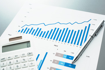 Poster - Reviewing financial report. Graphs and charts.　Business document, calculator and pen. 
