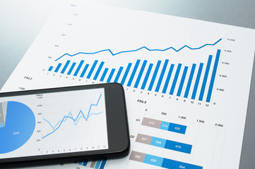Poster - Reviewing financial report. Document and smart phone.　Business document and smart phone on gray reflection background. 
