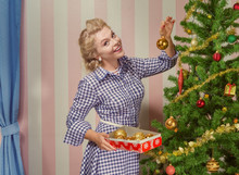 Portrait Of Nice Young Woman Hanging Around Christmas Tree On X-mas  Eve  