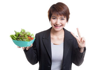 Healthy Asian business woman show victory sign with salad.