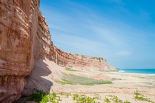Towering Red Sandstone Cliffs At Angola's Coast Line