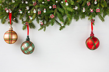 Christmas background. Christmas fir tree with decoration on white wooden board background. Top view, copy space. 