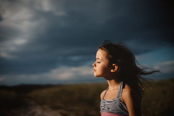 Girl on beach with wind in hair