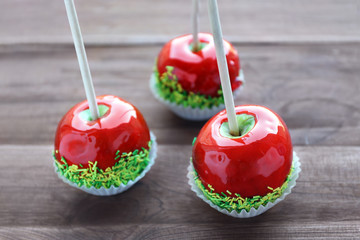 Sticker - Candy apples on wooden background