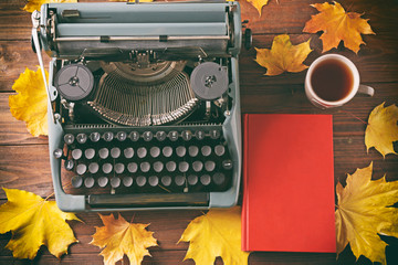 Sticker - Book with cup of tea and vintage typing machine on table