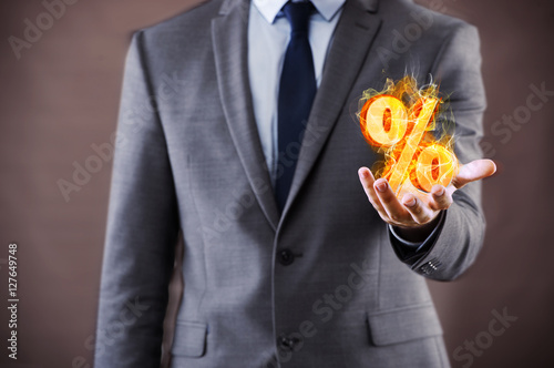 Fotografía Businessman with percent sign in high interest concept