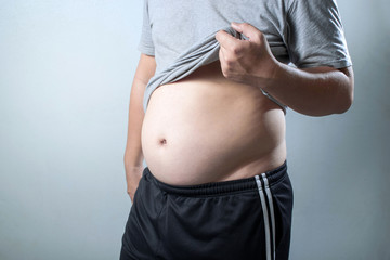 portrait of a asian fat man show out his body and big belly.