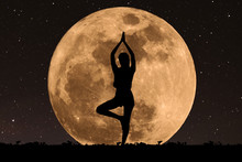 Silhouette Young Woman With Good Shape Practicing Yoga Under Full Moon At Night With Stars