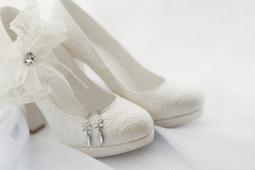 macro photo of white wedding shoes