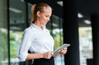 © Drobot Dean - Businesswoman using digital tablet while standing at the glass railing