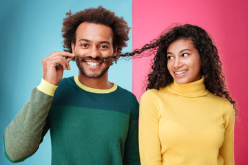 Wall Mural - Happy man making moustache with hair of his girlfriend