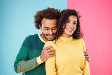 Wall Mural - Cute tender african couple standing and hugging