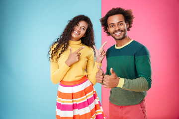 Wall Mural - Smiling african american young couple showing thumbs up