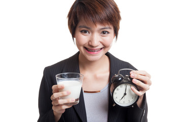 Sticker - Healthy Asian woman drinking  glass of milk hold clock.