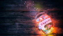 Garlands Of Colored Lights In Glass Jar With Dreams