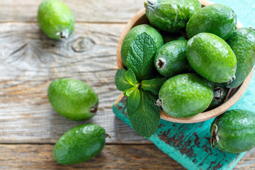 Wall Mural - Ripe feijoa in a wooden bowl.