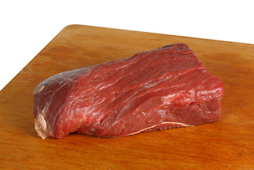 Raw beef meat fillet on wood board. On white background