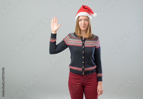 Fotomural Woman wearing Santa hat showing Vulcan salute