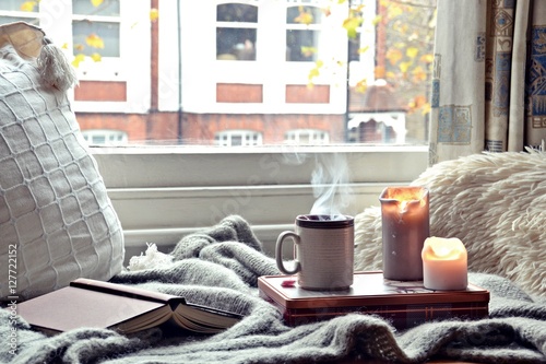 Cozy home. Candles, book and cup of tea Tableau sur Toile