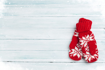 Christmas wooden background with mittens