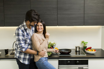 Wall Mural - Young couple preparing meal