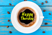 Happy Thursday Word On Coffee Cup At Blurred Blue Wooden Background With Beans