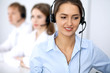 © rogerphoto - Call center. Focus on beautiful woman in headset
