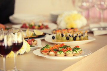 Poster - Plate with tasty tartlets on table served for holiday buffet