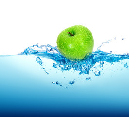 fresh green apple in blue Water splash with bubbles on white bac