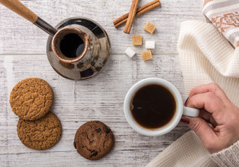 woman drinking coffee with cookies top view