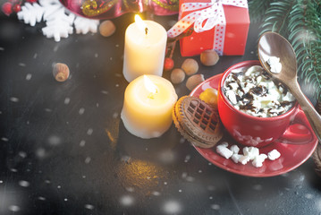 cup of cocoa with marshmallows and Christmas gifts in the backgr