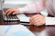 © rogerphoto - Close up of business woman hands using credit card and laptop computer