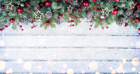 snowy fir branches with christmas ornament on table