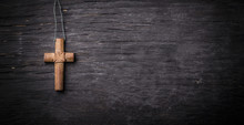 Brown Cross On A Black Wooden Background