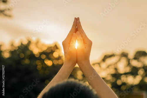 Fotomural Silhouette people pray from Buddha statue to hope for help on sun set and bokeh background