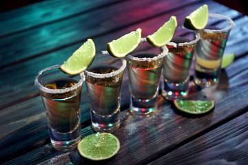 Canvas Print - Gold tequila shots with lime and salt in bar