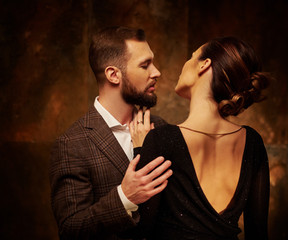 Wall Mural - Portrait of well-dressed couple in expression of feelings