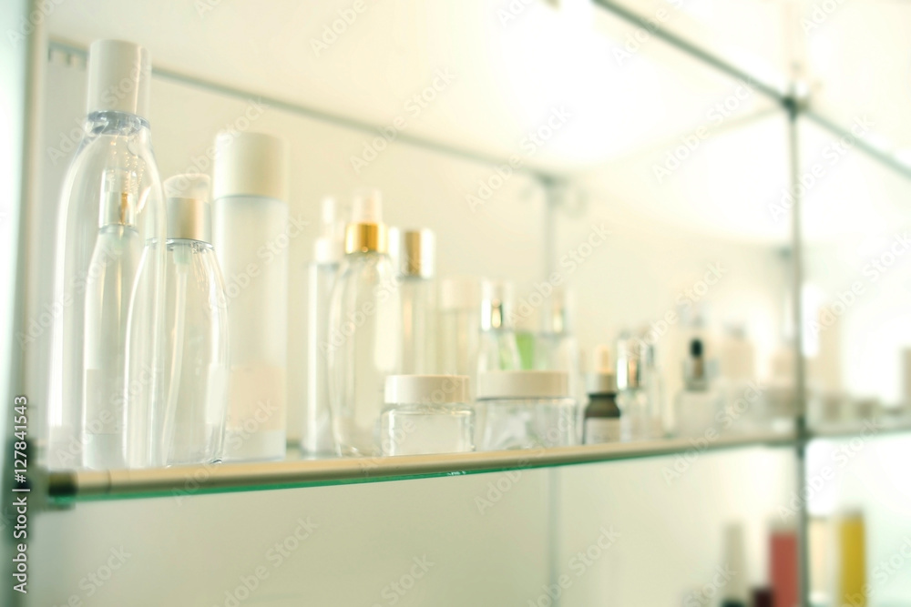 Stand with different containers for cosmetic products in retail shop